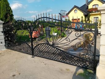 Czarna kuta brama wjazdowa dwuskrzydłowa BU 112 ze zdobieniami w kształcie liści winogron